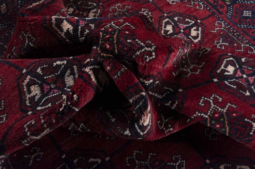 Corner detail of 2000s Baloch rug showing border pattern and Wool pile
