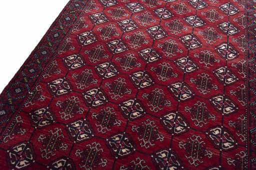 Backside of handmade 2000s Baloch rug showing knot structure and weave density