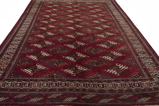 Surface texture of 1970s Baloch rug with natural Wool and intricate pattern