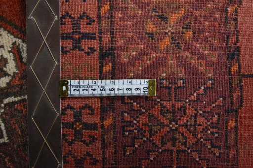 Surface texture of 1970s Baloch rug with natural Wool and intricate pattern