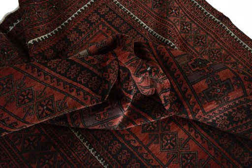 Corner detail of 2000s Baloch rug showing border pattern and Wool pile