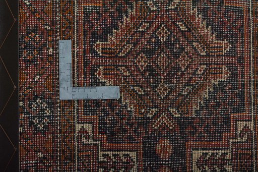 Corner detail of 2000s Baloch rug showing border pattern and Wool pile