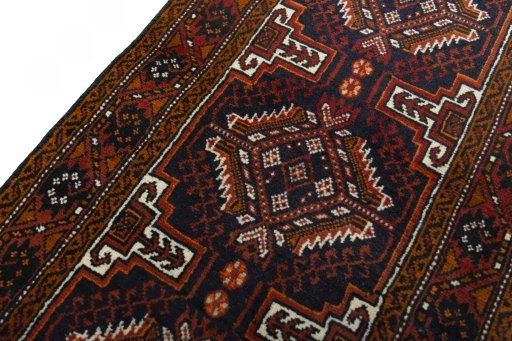 Backside of handmade 2000s Baloch rug showing knot structure and weave density