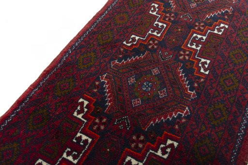 Backside of handmade 2000s Baloch rug showing knot structure and weave density