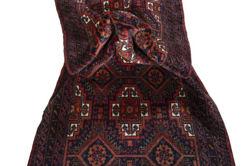 Corner detail of 2000s Baloch rug showing border pattern and Wool pile