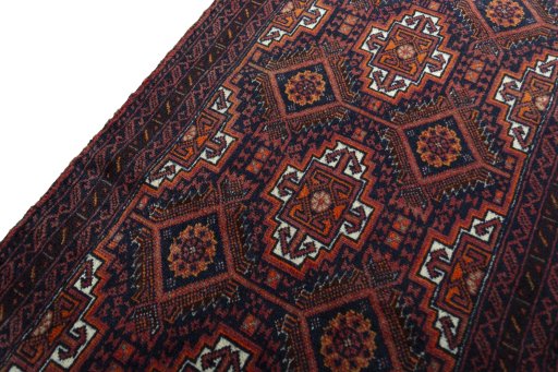 Backside of handmade 2000s Baloch rug showing knot structure and weave density