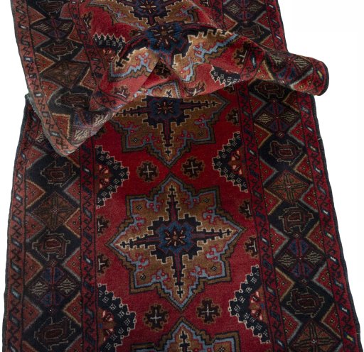 Corner detail of 2000s Baloch rug showing border pattern and Wool pile