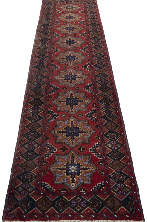 Surface texture of 2000s Baloch rug with natural Wool and intricate pattern