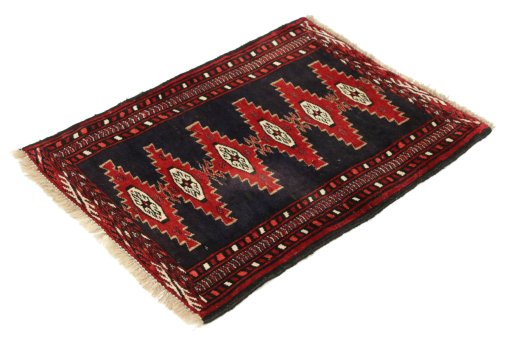 Corner detail of 1990s Baloch rug showing border pattern and Wool pile