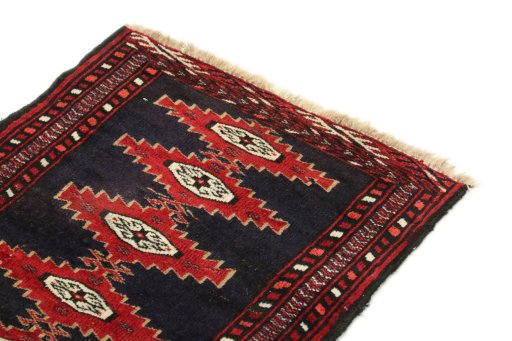 Surface texture of 1990s Baloch rug with natural Wool and intricate pattern
