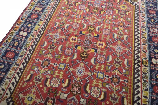 Backside of handmade 2000s Ghashghai rug showing knot structure and weave density