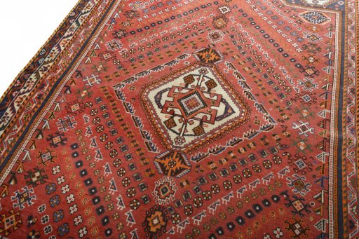 Backside of handmade 2000s Ghashghai rug showing knot structure and weave density