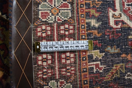 Surface texture of 2000s Ghashghai rug with natural Wool and intricate pattern