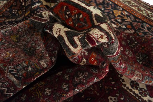 Corner detail of 2000s Ghashghai rug showing border pattern and Wool pile