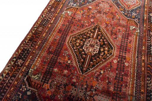 Backside of handmade 2000s Ghashghai rug showing knot structure and weave density