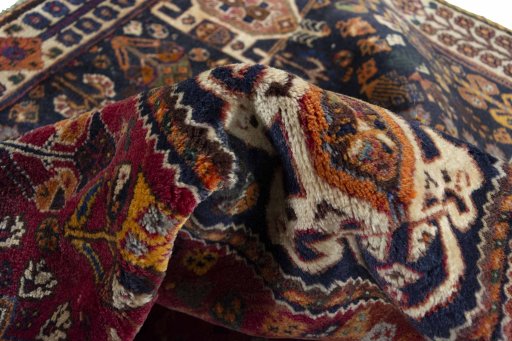 Corner detail of 2000s Ghashghai rug showing border pattern and Wool pile