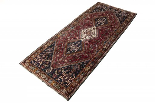 Corner detail of 2000s Ghashghai rug showing border pattern and Wool pile
