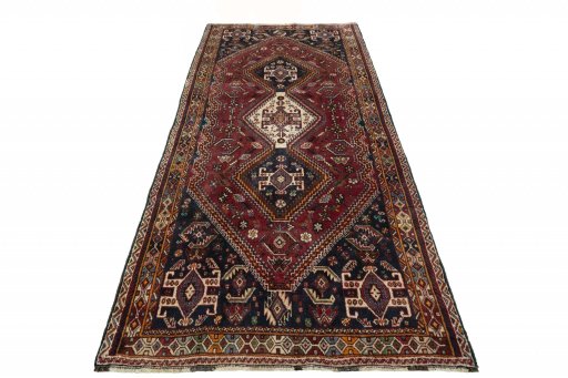 Surface texture of 2000s Ghashghai rug with natural Wool and intricate pattern