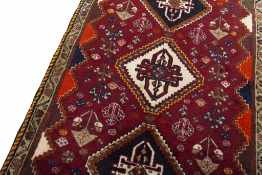 Backside of handmade 2000s Ghashghai rug showing knot structure and weave density