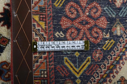 Backside of handmade 2000s Ghashghai rug showing knot structure and weave density