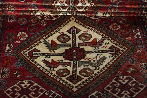 Full view of 1950s Ghashghai rug from Iran / Persia, 264 × 140 cm in Red tones