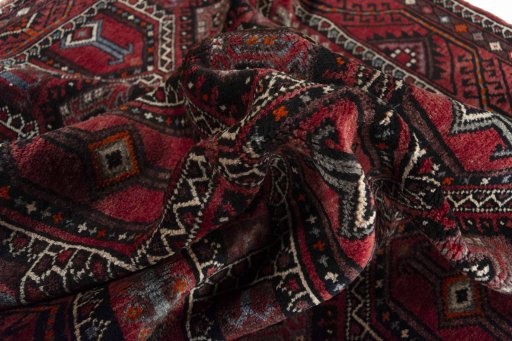 Corner detail of 2000s Hamedan rug showing border pattern and Wool pile