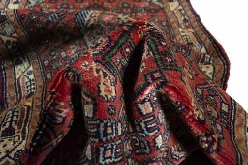 Corner detail of 2000s Hamedan rug showing border pattern and Wool pile