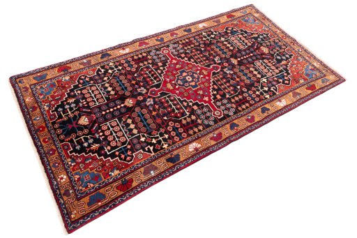 Corner detail of 1975s Hamedan rug showing border pattern and Wool pile