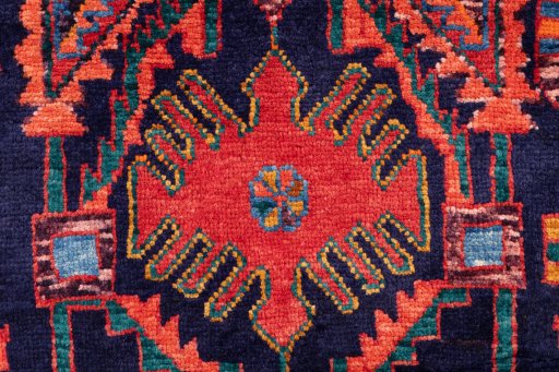 Corner detail of 1999s Hamedan rug showing border pattern and Wool pile