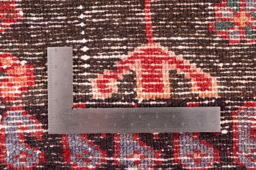 Backside of handmade 1975s Hamedan rug showing knot structure and weave density