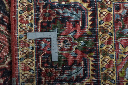 Backside of handmade 1930s Heriz rug showing knot structure and weave density