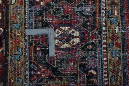 Backside of handmade 1930s Heriz rug showing knot structure and weave density