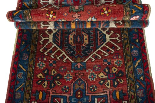 Full view of 1930s Heriz rug from Iran / Persia, 320 × 85 cm in Red tones