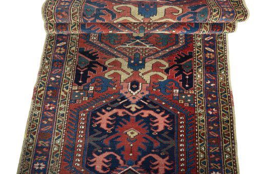 Full view of 1930s Heriz rug from Iran / Persia, 326 × 96 cm in Red tones