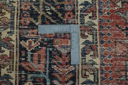 Backside of handmade 1930s Heriz rug showing knot structure and weave density