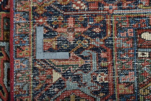 Backside of handmade 1930s Heriz rug showing knot structure and weave density