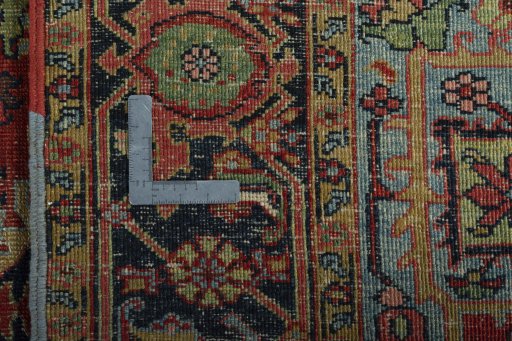 Backside of handmade 1930s Heriz rug showing knot structure and weave density