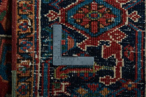 Backside of handmade 1930s Heriz rug showing knot structure and weave density