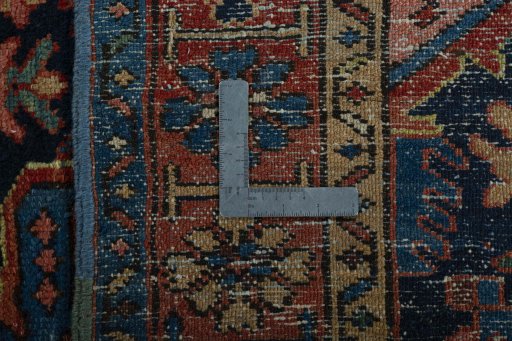Backside of handmade 1930s Heriz rug showing knot structure and weave density