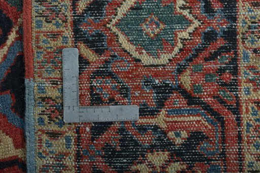 Backside of handmade 1930s Heriz rug showing knot structure and weave density