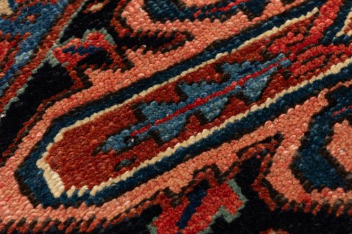 Backside of handmade 1990s Heriz rug showing knot structure and weave density