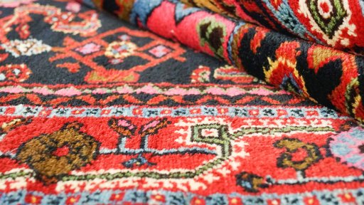 Close-up detail of 1920s Malayer rug from Iran / Persia showing Wool weave