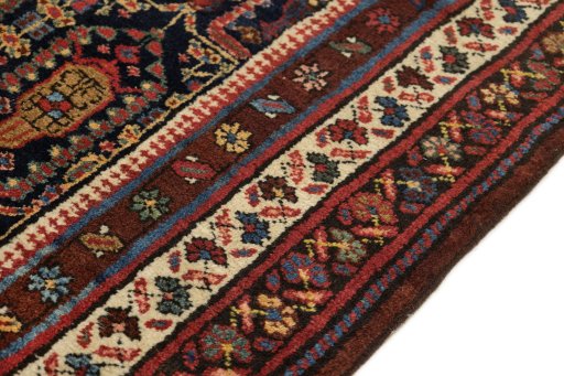 Backside of handmade 1930s Meshkin rug showing knot structure and weave density