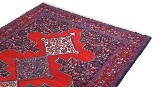 Surface texture of 1940s Senneh rug with natural Wool and intricate pattern