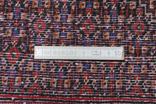 Corner detail of New Senneh rug showing border pattern and Wool pile