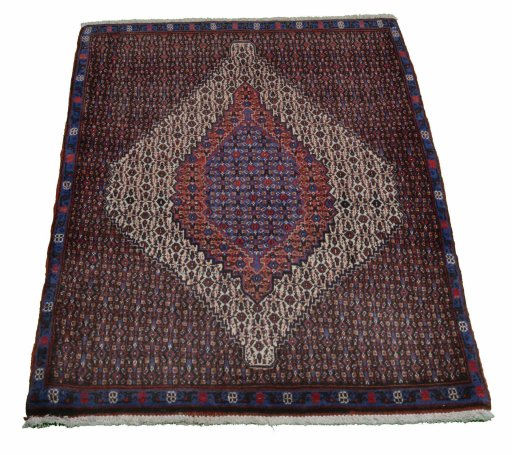 Backside of handmade New Senneh rug showing knot structure and weave density