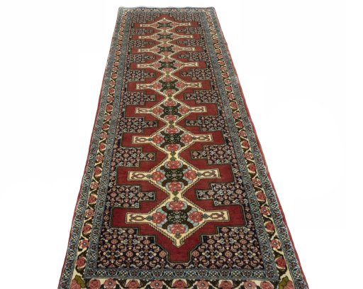 Surface texture of 2000s Senneh rug with natural Wool and intricate pattern