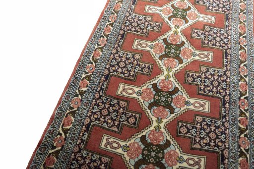 Backside of handmade 2000s Senneh rug showing knot structure and weave density