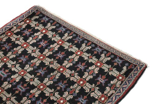 Surface texture of 1950s Senneh rug with natural Wool and intricate pattern
