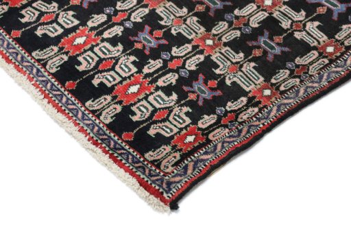 Backside of handmade 1950s Senneh rug showing knot structure and weave density